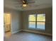 Main bedroom with ceiling fan, en-suite bathroom access, and walk-in closet at 3 Fisher Loop Crse, Ocklawaha, FL 32179