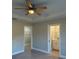 Main bedroom with ceiling fan and en-suite bathroom access at 3 Fisher Loop Crse, Ocklawaha, FL 32179