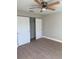 Bedroom with double door closet and ceiling fan at 3 Fisher Loop Crse, Ocklawaha, FL 32179