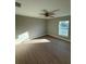 Spacious bedroom featuring wood-look vinyl flooring and a ceiling fan at 3 Fisher Loop Crse, Ocklawaha, FL 32179