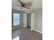 Bright bedroom with ceiling fan, large closet, and wood-look flooring at 3 Fisher Loop Crse, Ocklawaha, FL 32179