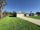 Newly built home with a two-car garage and grassy front yard at 3 Fisher Loop Crse, Ocklawaha, FL 32179