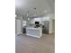 Modern kitchen with white cabinets, stainless steel appliances, and an island at 3 Fisher Loop Crse, Ocklawaha, FL 32179