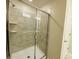 Clean and spacious shower with glass enclosure and tile surround at 3151 Paradox Cir # 103, Kissimmee, FL 34746