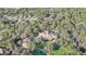 Aerial view of a large clubhouse nestled in a wooded area of a community at 32604 View Haven Ln, Sorrento, FL 32776