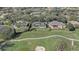 An aerial view showcases the property's location near a golf course, mature trees, and neighboring residences at 32604 View Haven Ln, Sorrento, FL 32776
