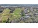 Aerial view showing upscale homes, a golf course, and a lake in a Florida community at 32604 View Haven Ln, Sorrento, FL 32776