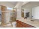 Well-lit bathroom featuring a tiled walk-in shower, vanity with ample counter space, and a mirror at 32604 View Haven Ln, Sorrento, FL 32776