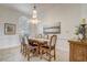 Elegant dining room featuring a rustic wooden table and chandelier at 32604 View Haven Ln, Sorrento, FL 32776