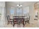 Dining room with a wood table and chairs, chandelier, and large window with natural light at 32604 View Haven Ln, Sorrento, FL 32776