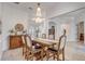 Formal dining room with a large chandelier and wooden table at 32604 View Haven Ln, Sorrento, FL 32776