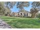 House exterior showcasing a manicured lawn and mature trees at 32604 View Haven Ln, Sorrento, FL 32776