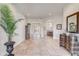 Bright foyer with tile floors, high ceilings, decorative columns, and a view into the dining area at 32604 View Haven Ln, Sorrento, FL 32776