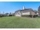 Back exterior of house showing lawn, landscaping, and patio at 32604 View Haven Ln, Sorrento, FL 32776