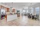 Open-concept kitchen with stainless steel appliances, a central island, and views into the living room at 32604 View Haven Ln, Sorrento, FL 32776