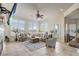 Spacious living room with tile floors, a ceiling fan, comfortable furniture, and large windows at 32604 View Haven Ln, Sorrento, FL 32776