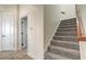 Staircase with carpeted steps and wood railing at 32604 View Haven Ln, Sorrento, FL 32776