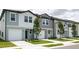 New townhouses with attached garages and landscaping at 3265 Vesara Dr, Davenport, FL 33837