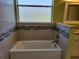 Bathroom with a large soaking tub and updated tile at 370 Silver Maple Rd, Groveland, FL 34736