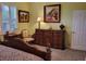 Main bedroom with large dresser, comfortable chair and natural light at 370 Silver Maple Rd, Groveland, FL 34736