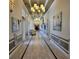 Bright clubhouse hallway with chandeliers and comfortable seating at 370 Silver Maple Rd, Groveland, FL 34736