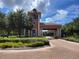 Gated community entrance with a brick-paved road and lush landscaping at 370 Silver Maple Rd, Groveland, FL 34736