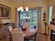 Elegant dining room featuring a round wooden table and access to a screened patio at 370 Silver Maple Rd, Groveland, FL 34736