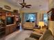 Open concept living room with hardwood floors and ample natural light at 370 Silver Maple Rd, Groveland, FL 34736