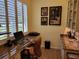 Home office with built-in workspace and window with plantation shutters at 370 Silver Maple Rd, Groveland, FL 34736