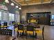 Community restaurant with stylish yellow chairs and dark wood tables at 370 Silver Maple Rd, Groveland, FL 34736