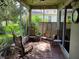 Relaxing screened porch with patio furniture, perfect for enjoying the Florida weather at 370 Silver Maple Rd, Groveland, FL 34736