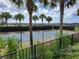 Community tennis court with black fence and palm trees at 370 Silver Maple Rd, Groveland, FL 34736