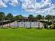 Two tennis courts with surrounding landscaping at 370 Silver Maple Rd, Groveland, FL 34736