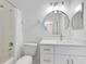 Bathroom with white vanity, round mirror, and shower/tub combo at 3721 Cleary Way, Orlando, FL 32828