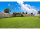 Spacious backyard with grassy lawn and wooden fence at 4 Sea Hawk Dr, Ormond Beach, FL 32176