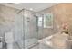 Modern bathroom with a large walk-in shower, marble tile and a floating vanity at 4 Sea Hawk Dr, Ormond Beach, FL 32176