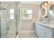 Spa-like bathroom with a double vanity, marble tile, and a large mirror at 4 Sea Hawk Dr, Ormond Beach, FL 32176