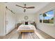 Bright bedroom with hardwood floors, a queen bed, and sliding barn door at 4 Sea Hawk Dr, Ormond Beach, FL 32176