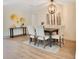 Bright dining room with hardwood floors, a farmhouse table and six chairs at 4 Sea Hawk Dr, Ormond Beach, FL 32176