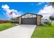 House exterior with stone and brown garage door at 4 Sea Hawk Dr, Ormond Beach, FL 32176