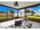 Screened porch with patio furniture and backyard view at 4 Sea Hawk Dr, Ormond Beach, FL 32176