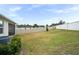 Spacious backyard with a grassy area and privacy fence at 4398 Davos Dr, Clermont, FL 34711