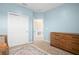 Spacious bedroom with double doors and wood dresser at 4398 Davos Dr, Clermont, FL 34711