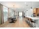 Open concept dining area with hardwood floors and chandelier at 4398 Davos Dr, Clermont, FL 34711