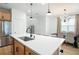 Kitchen island with white countertop and a farmhouse sink at 4398 Davos Dr, Clermont, FL 34711