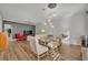 Dining area with glass table, white chairs, and exposed brick wall at 4487 Twinview Ln, Orlando, FL 32814