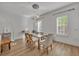 Dining area with glass table, white chairs, and exposed brick wall at 4487 Twinview Ln, Orlando, FL 32814