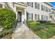 Townhome's front entrance with columns, steps, and landscaping at 4487 Twinview Ln, Orlando, FL 32814