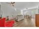 Living room with sectional sofa, red armchair, and exposed brick wall at 4487 Twinview Ln, Orlando, FL 32814