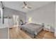 Main bedroom with gray bedding, white dresser, and exposed brick wall at 4487 Twinview Ln, Orlando, FL 32814